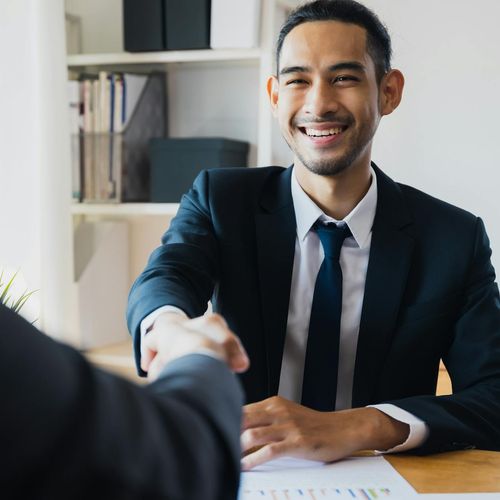 Portrait of a smiling, confident person sharing a positive story.